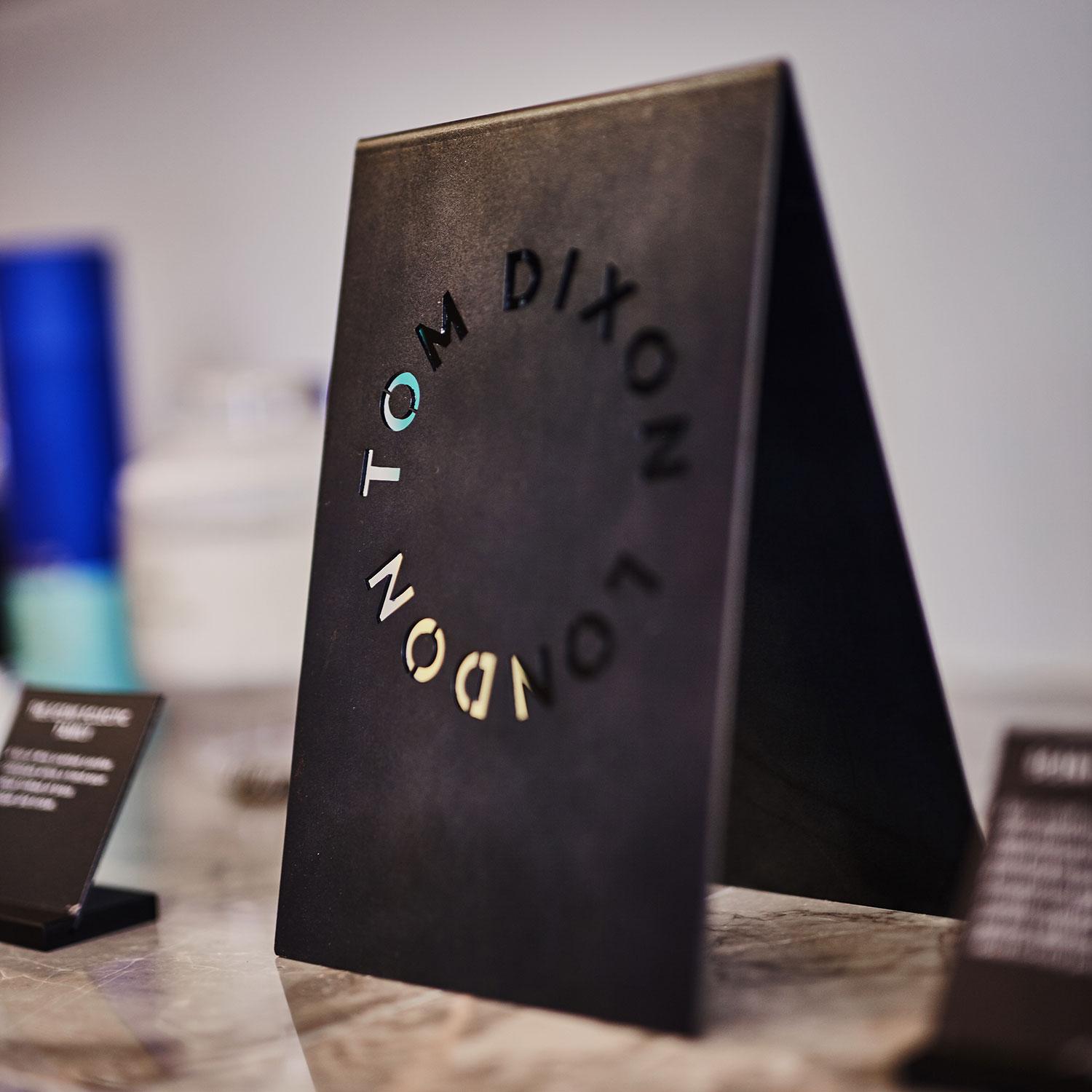 Close-up of Tom Dixon menu sign at café in Hong Kong
