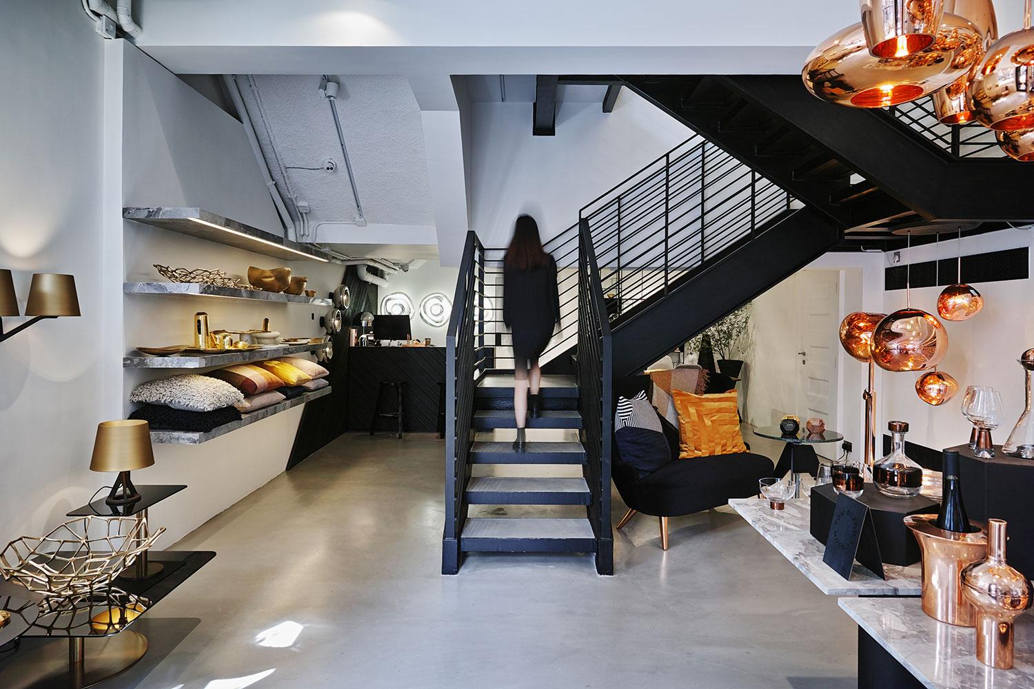 Modern café interior in Hong Kong with Tom Dixon lighting and stylish staircase