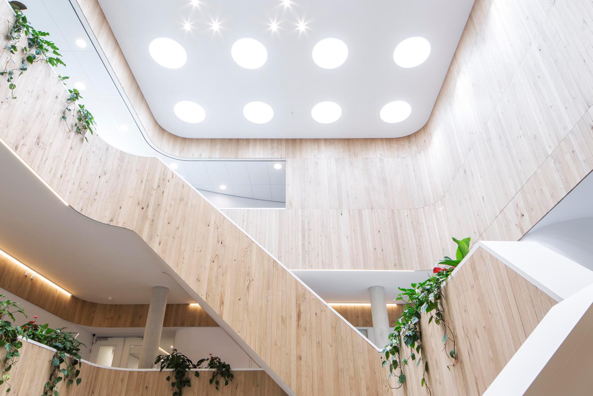 Office atrium in Enschede with Acosorb acoustic ceiling panels and natural light